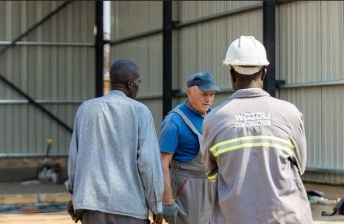 Wozoli Construction site team in branded worksuits on an industrial build